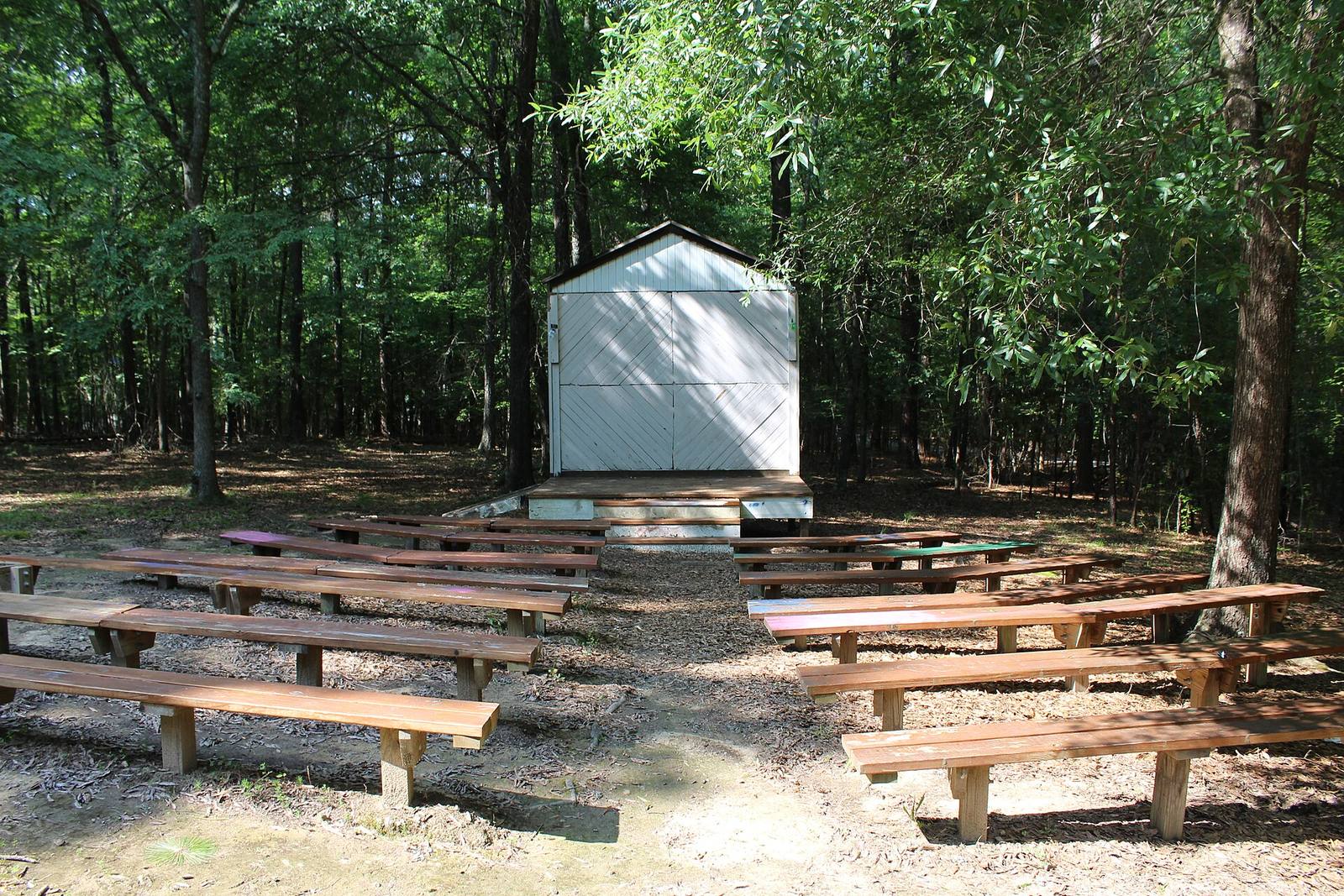 Carrboro Elementary forest stage with rows of plank benches