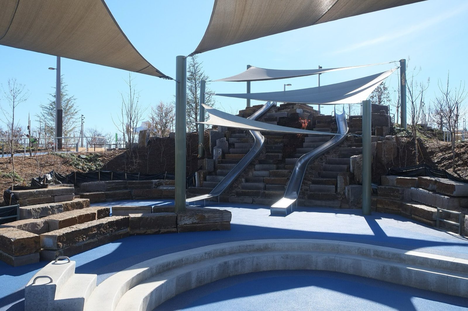 Gathering Place, Slide Hill with two metal slides and stepped stone stairs