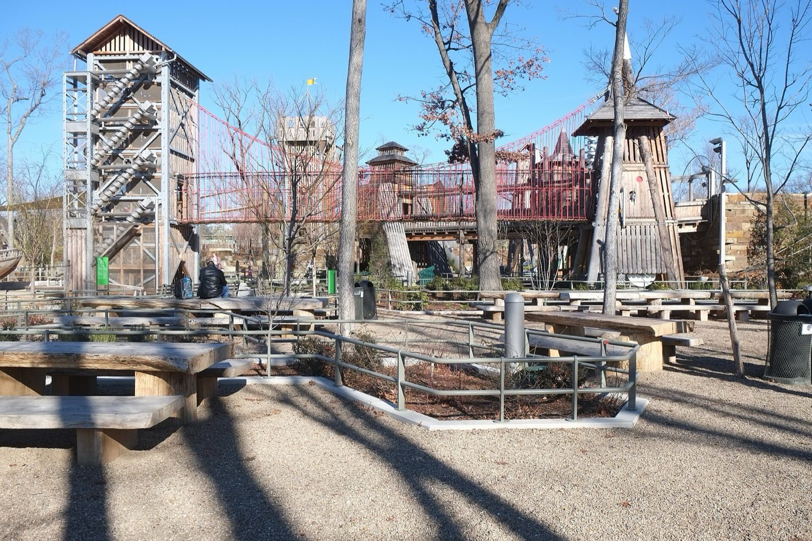 Gathering Place, timber and steel towers joined by a red rope bridge