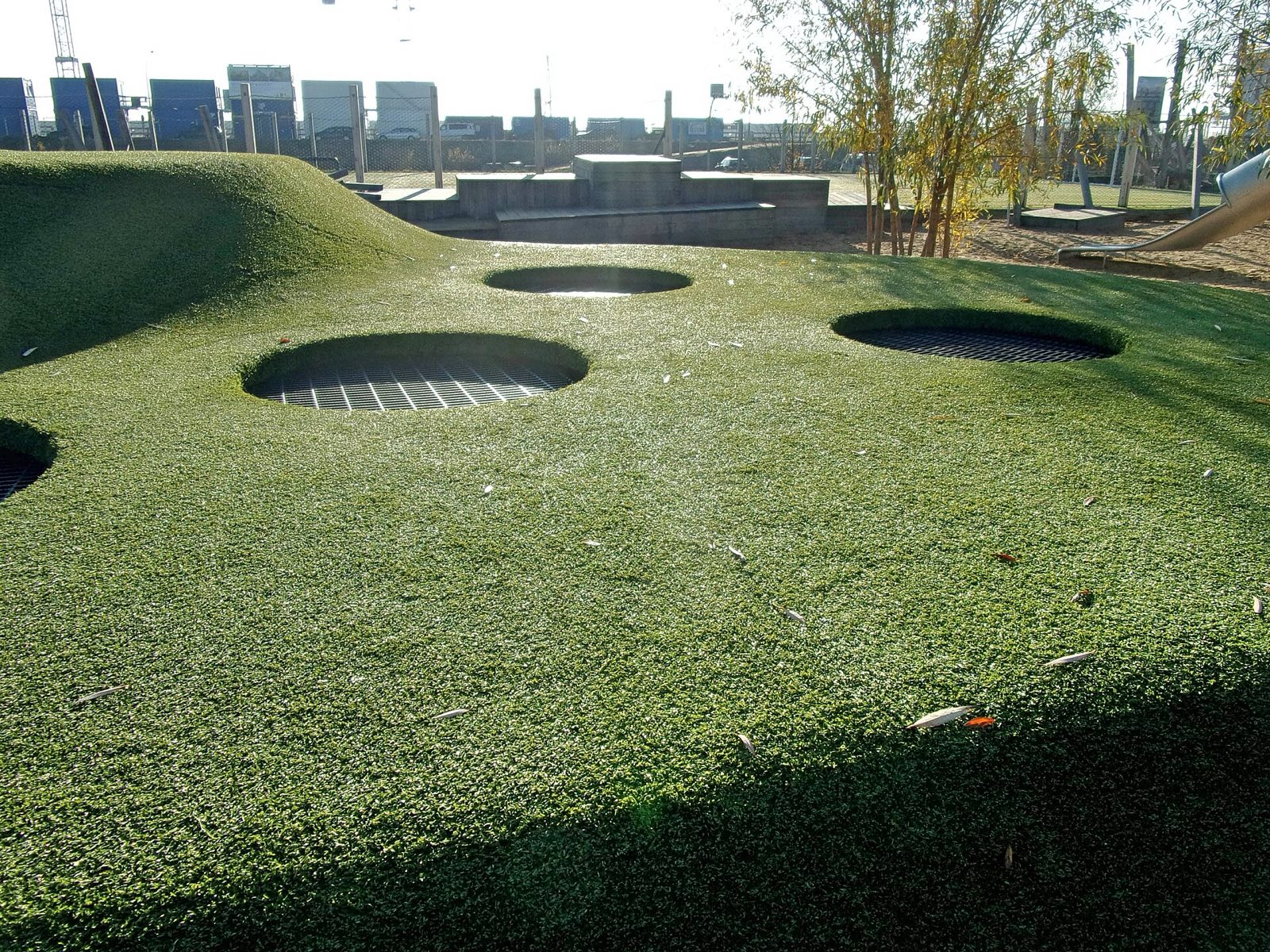 Baakenpark playground: in-ground trampolines in an artificial grass mound
