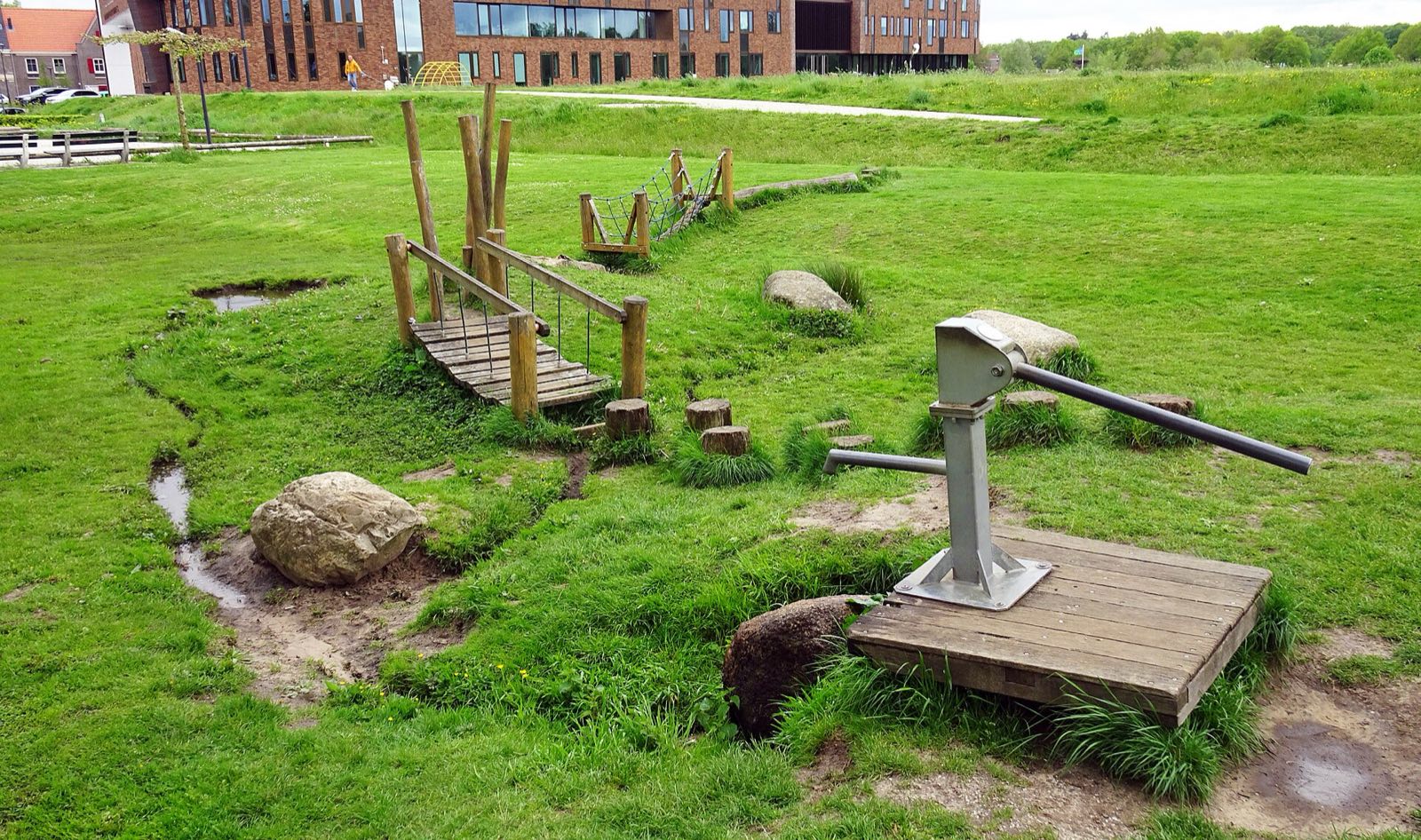 Dalfsen, natural play area with hand pump, plank bridge, stepping stumps and boulders