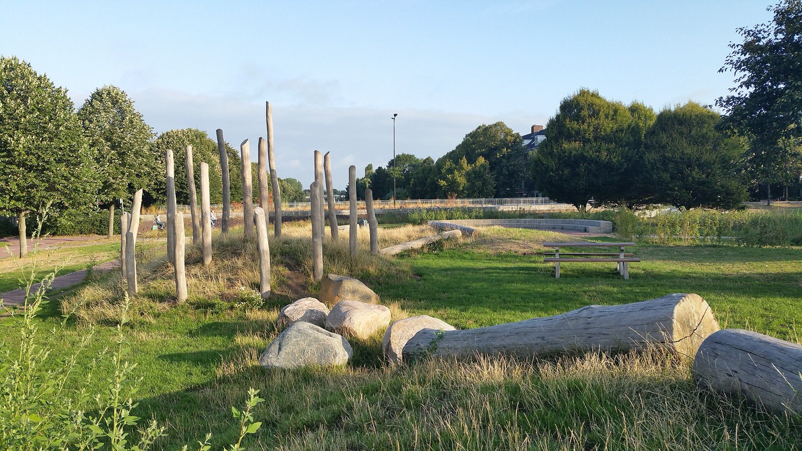 Natural play area with log seats, boulders and peeled log palisade, Netherlands