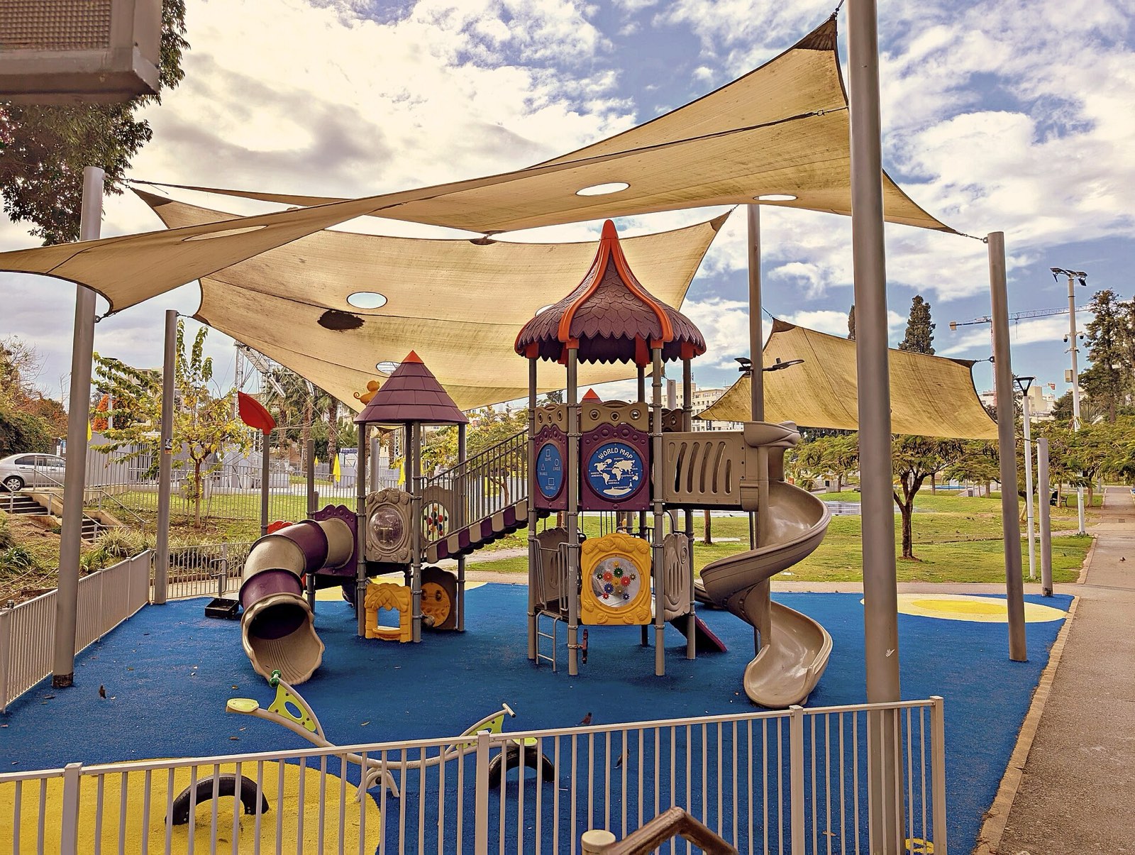 Founders Park: Layered shade sails over a themed play structure
